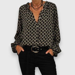 Long-sleeve blouse with black-and-gold geometric pattern, V-neck, relaxed fit
