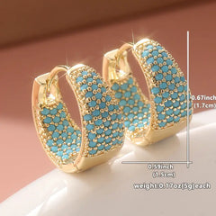 Gold-tone hoop earrings with turquoise beadwork lattice detail, close-up view