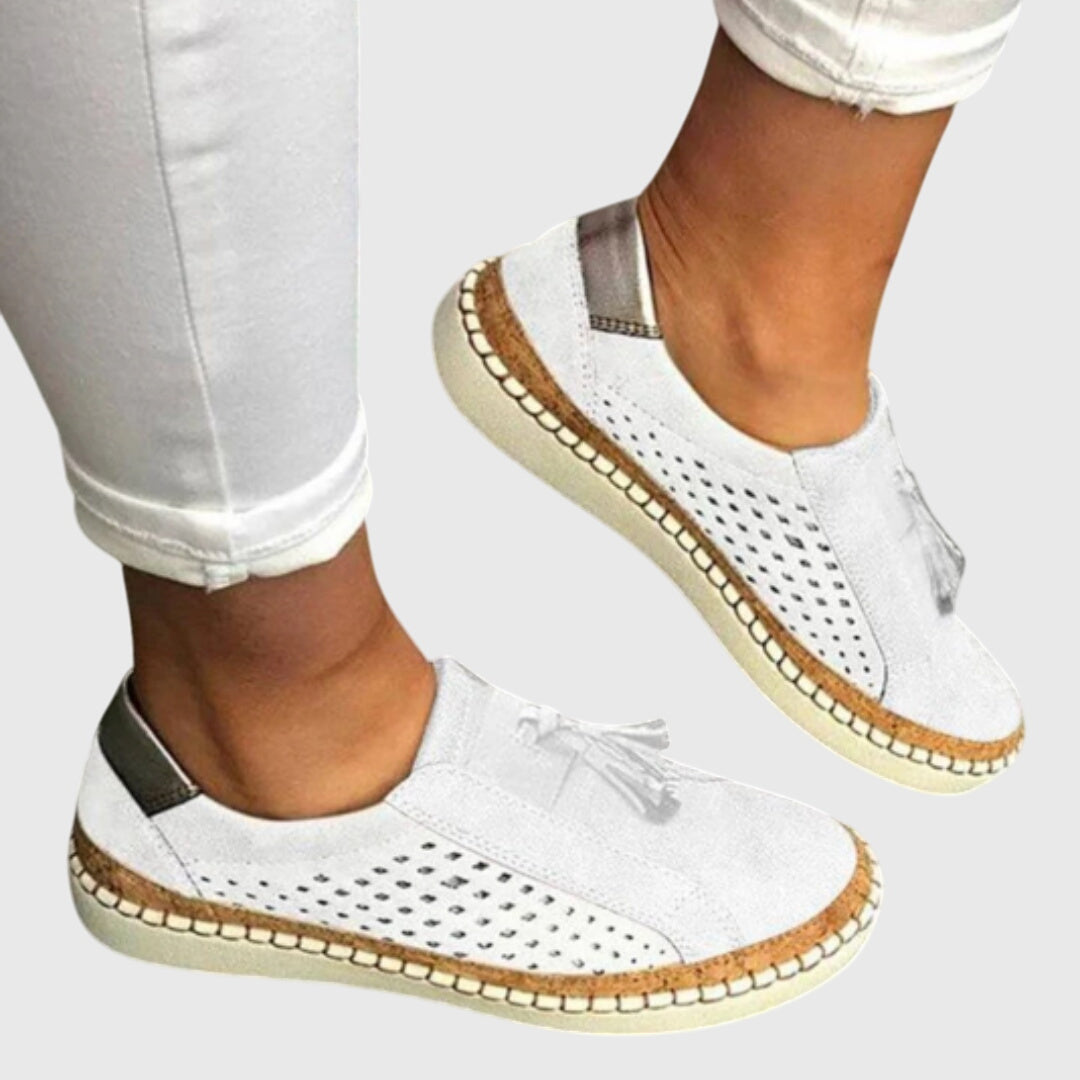 White perforated comfort slip-on shoes with tassel detail and tan stitched sole