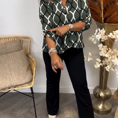 Olive green long-sleeve button-up blouse with white interlocking oval pattern