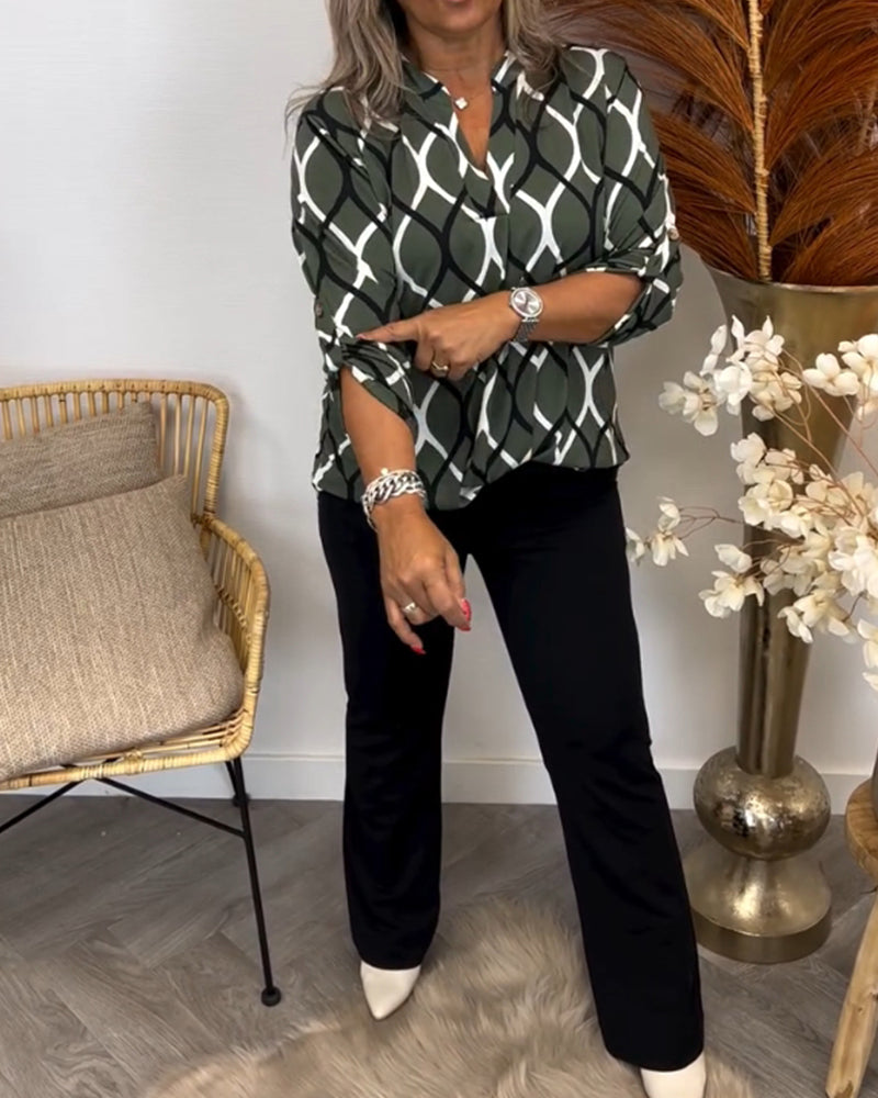 Olive green long-sleeve button-up blouse with white interlocking oval pattern