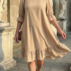 Beige ruffle day dress with gathered waist seam and tiered ruffle hem