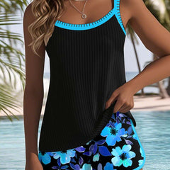 Two-piece beach tankini set with black sleeveless top and blue floral shorts, turquoise border.