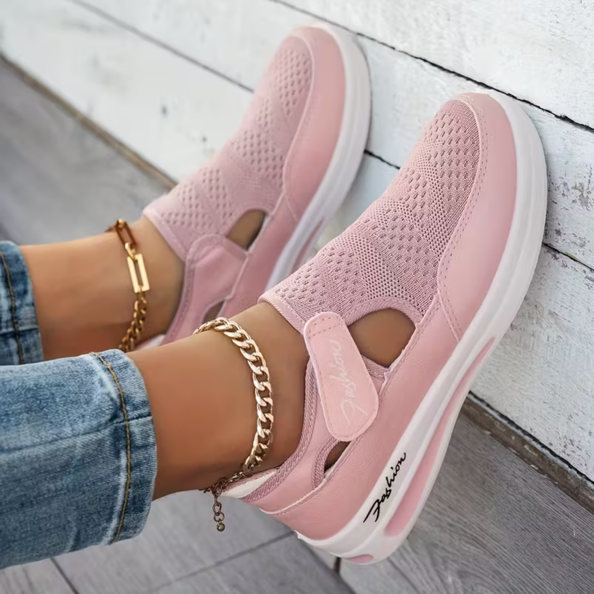 Pink perforated comfort sneakers with side cutout, elastic strap, and white sole