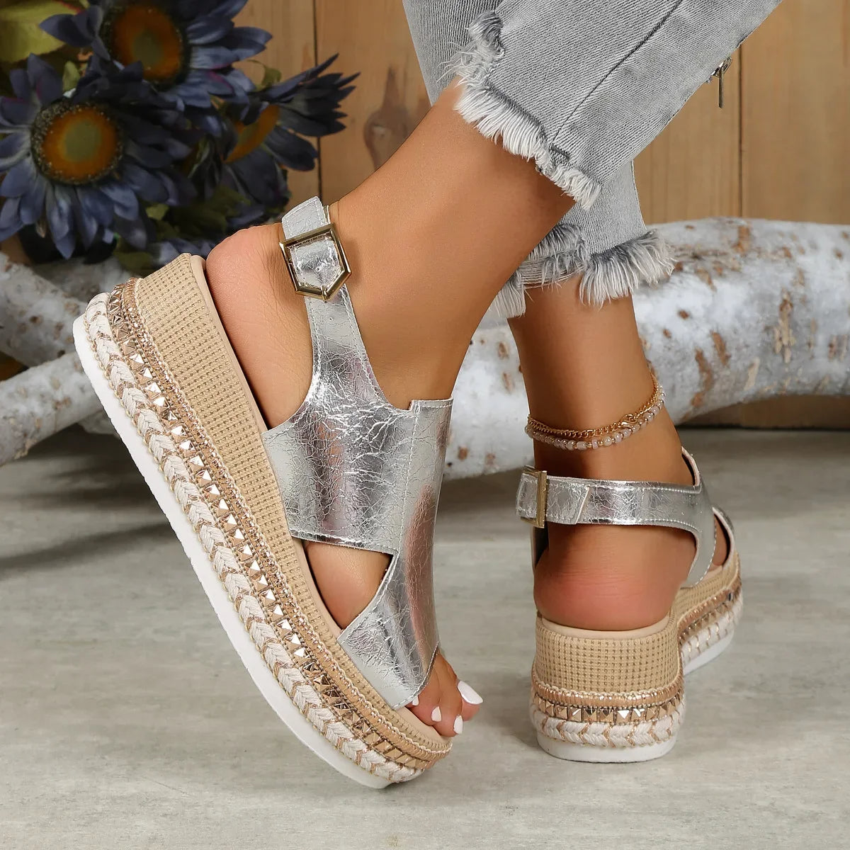 Silver metallic open-toe platform sandals with ankle strap buckle and textured wedge sole