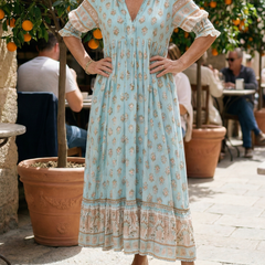 Sky blue V-neck tiered midi dress with short puff sleeves, floral pattern