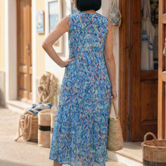 Back view of blue sleeveless printed midi dress with tiered skirt