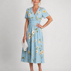 Light blue V-neck midi dress with small yellow daisy print and gathered waist
