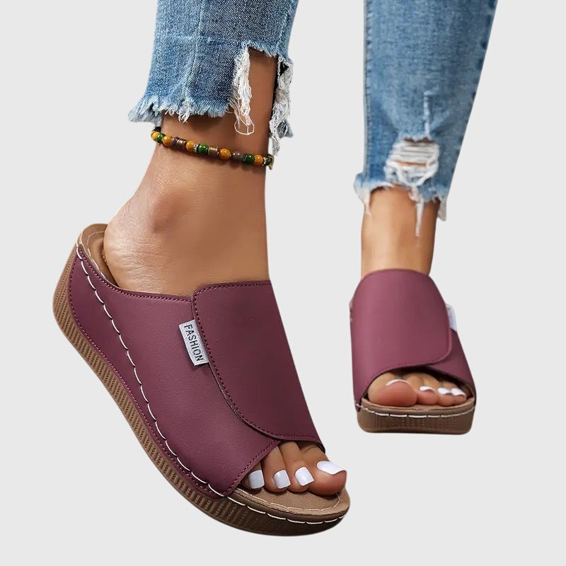 Purple wedge sandals with wide side strap and open toe, cushioned footbed