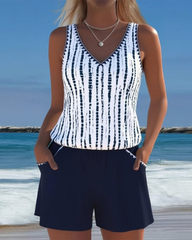 Navy two-piece V-neck swimsuit set with white vertical tie-dye stripe top and shorts