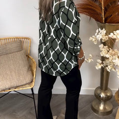 Olive green long-sleeve blouse with white oval linked geometric print, side view