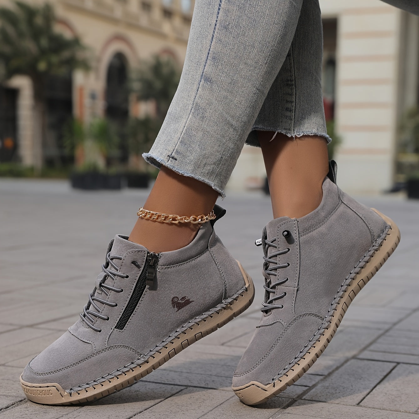 Light gray zip-up comfort shoes with lace-up front and side zipper, on feet