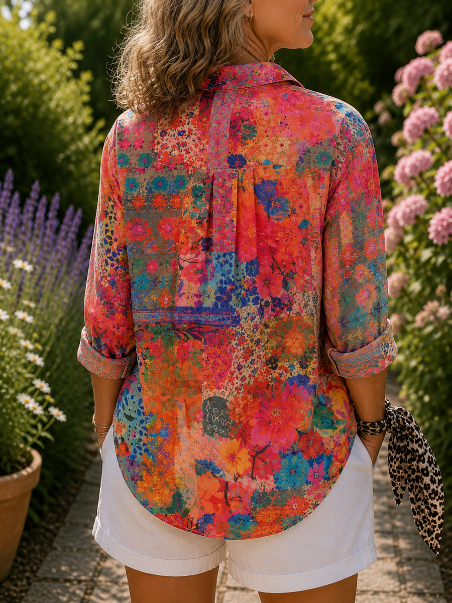 Colorful floral button-up blouse, back view with collar and rolled sleeves