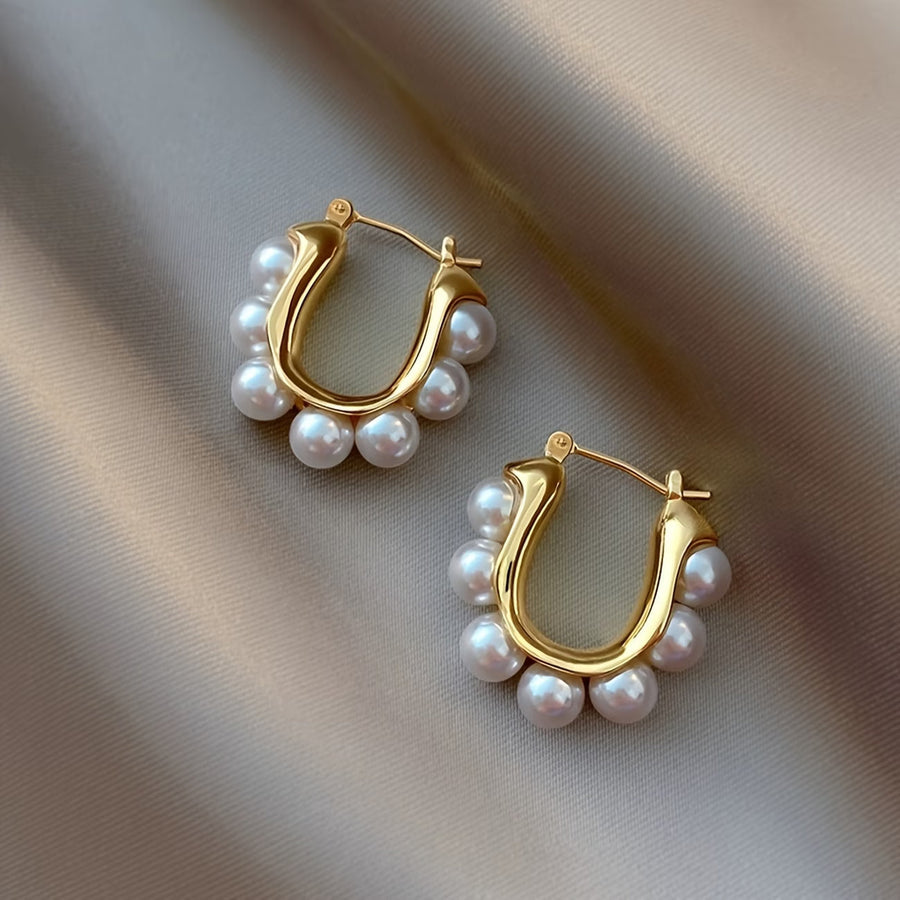 Gold hoop earrings with white pearl clusters and small top stud closures