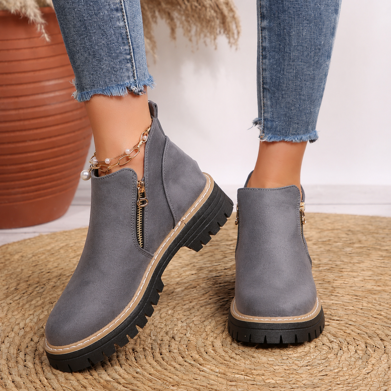 Women's ankle boots, gray suede-look with side zipper and rubber lug sole.