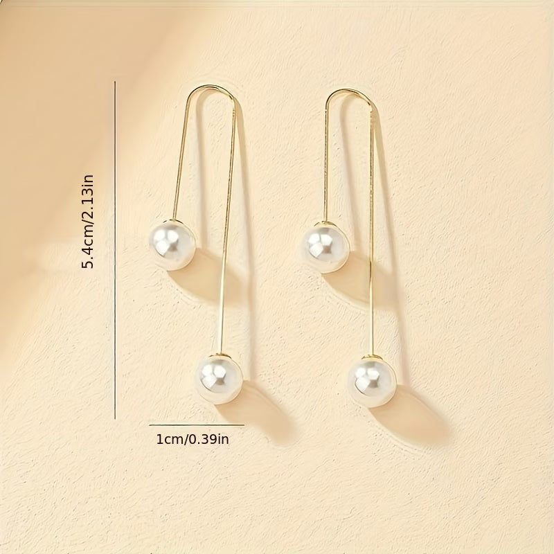 Pearl drop statement earrings in gold tone, two round pearls on thin hooks