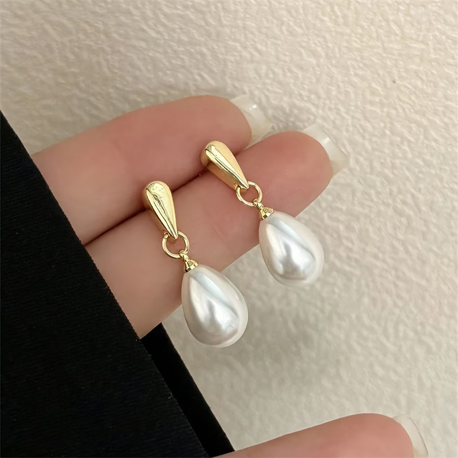 Gold hoop pearl drop earrings with large white teardrop pearls