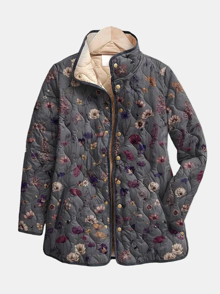 Quilted floral print jacket in dark gray with multicolor flowers; hood and snap buttons