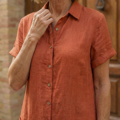 Close-up of orange linen-look courtyard walk dress: buttoned collar and short sleeves