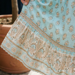 Sky blue tiered midi dress hem with lace trim and floral embroidery pattern