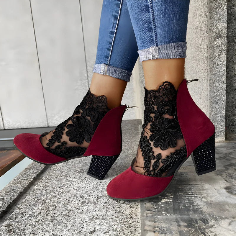 Red and black orthopedic heeled ankle boots with floral lace side panels and block heel