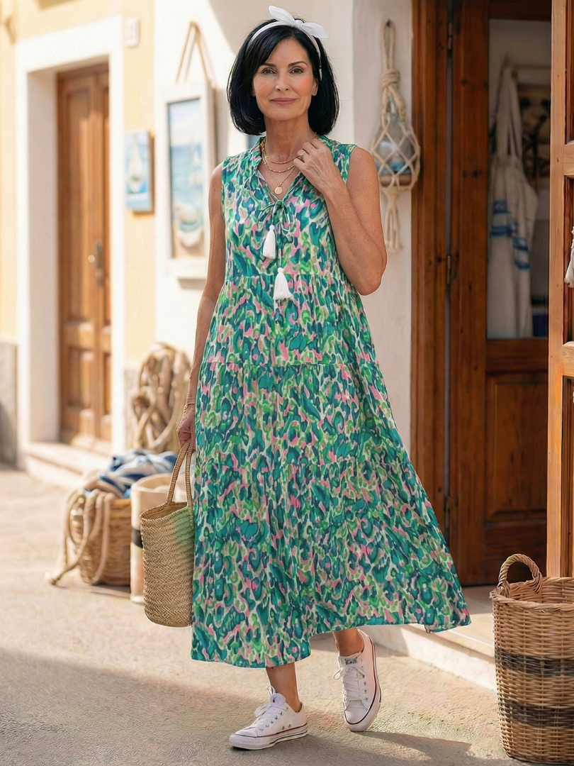 Green sleeveless V-neck printed midi dress with tassel-tie accents and tiered skirt