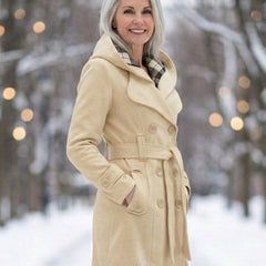 Cream wool hooded coat with plaid hood lining, belt tie, and buttoned sleeves.