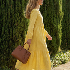 Yellow tiered midi dress with long sleeves and V-neck, side view