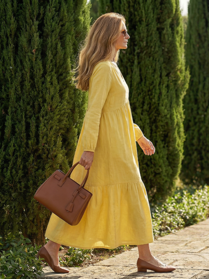 Yellow tiered midi dress with long sleeves and V-neck, side view