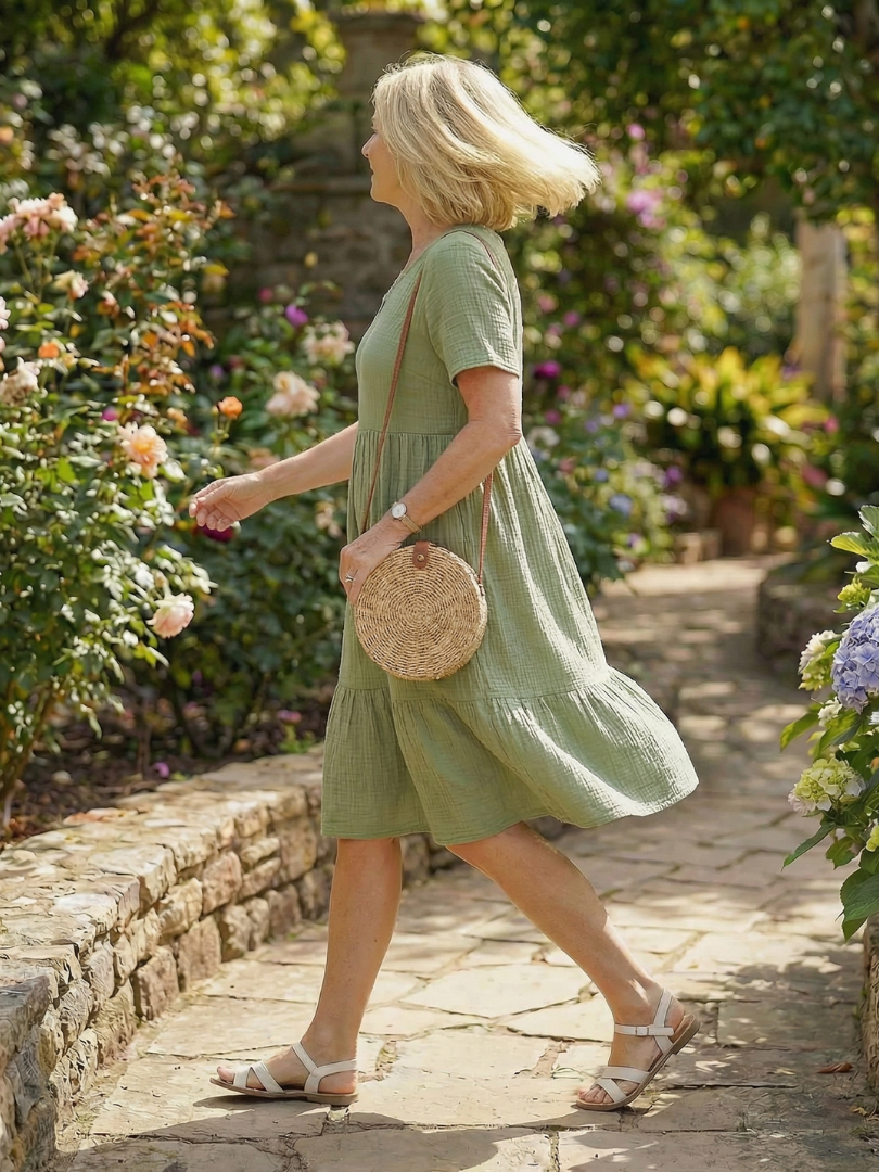 Green woven ease dress with V-neck and tiered skirt, short sleeves