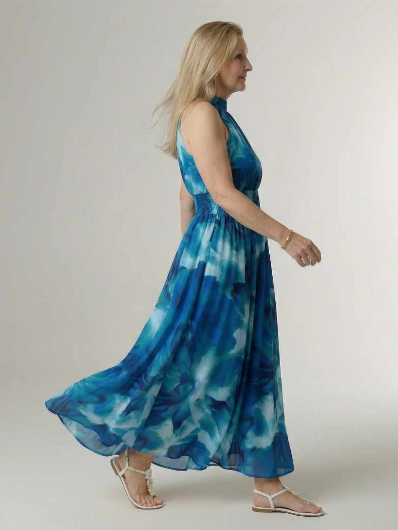 Blue gathered halter midi dress, side view, smocked bodice and full skirt