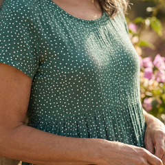Green Meadow Drift dress close-up: dotted bodice with gathered waist and short sleeves