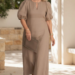 Taupe maxi dress with puff sleeves and keyhole neckline, gathered waist silhouette.
