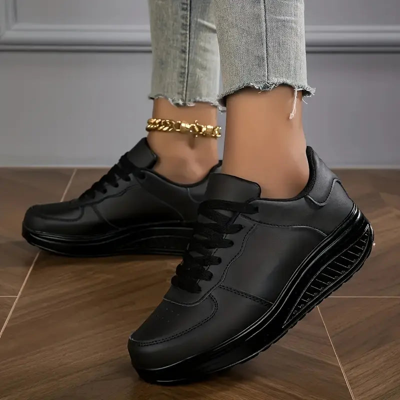 Black platform comfort sneakers with lace-up front and white sole trim