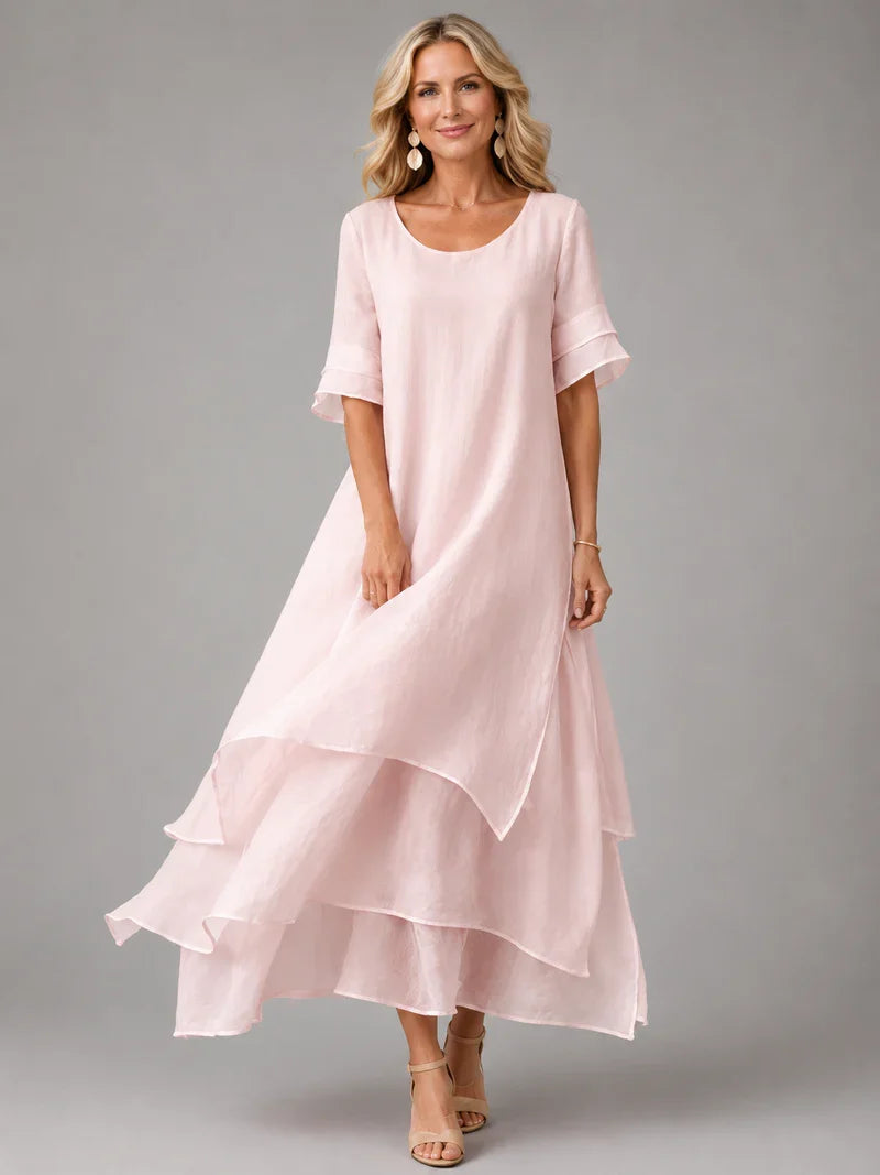 Pink cotton ruffle midi dress with short sleeves and layered tiered hem