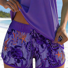 Purple ocean-print swim shorts with starfish and sea turtle motifs