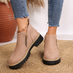 Women’s ankle boots in light beige suede with side zipper and lug sole.