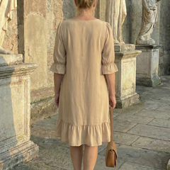 Beige ruffle day dress back view with tiered skirt and three-quarter puff sleeves