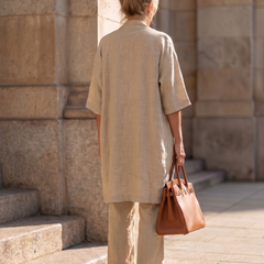 Beige three-piece set from behind: long cardigan and matching wide-leg trousers
