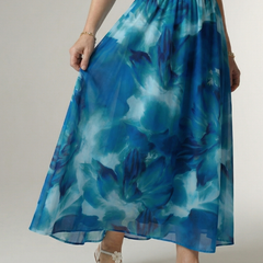 Blue gathered halter midi dress close-up, smocked waist and airy tiered hem
