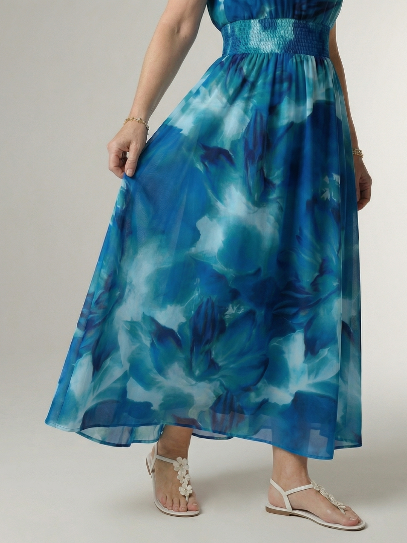 Blue gathered halter midi dress close-up, smocked waist and airy tiered hem