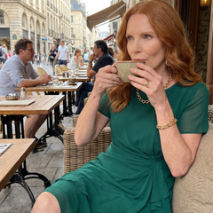 Green chiffon draped dress with short sleeves and layered ruffle hem