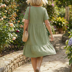 Green woven ease dress back view with tiered skirt and short sleeves