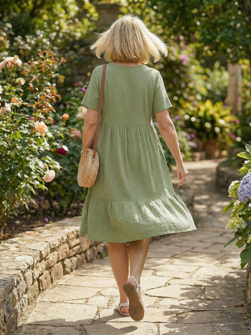 Green woven ease dress back view with tiered skirt and short sleeves