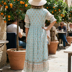 Sky blue V-neck tiered midi dress, back view, short puff sleeves, floral print