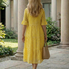 Yellow polka dot tiered midi dress back view with short sleeves and tiered hem