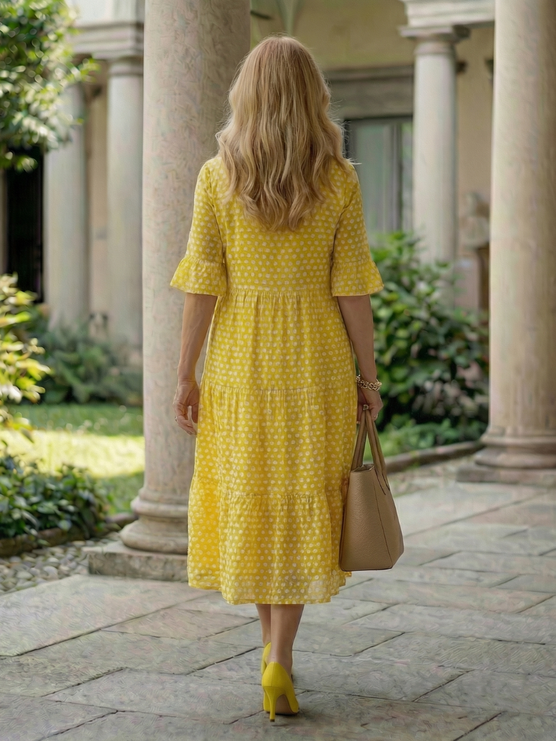 Yellow polka dot tiered midi dress back view with short sleeves and tiered hem