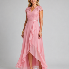 Pink lace evening dress with cap sleeves, sash waist, and asymmetrical ruffle hem