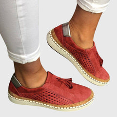 Red perforated comfort slip-on shoes with tassel detail and tan stitched sole