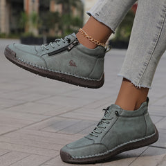 Gray zip-up comfort shoes, side zipper and patterned sole visible